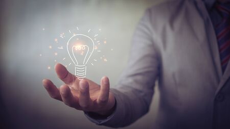 businessman holding icon light bulb,idea concept,,Presenting new ideas.の写真素材
