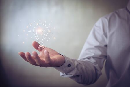 businessman holding icon light bulb,idea concept,,Presenting new ideas.の写真素材