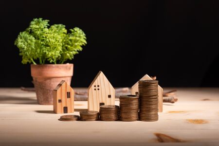 stacking dollar coins and house model with coppy space for text or design. Home loan conceptの写真素材