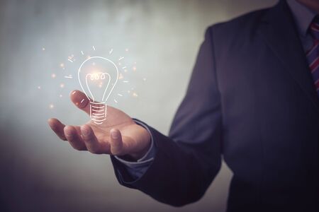 businessman holding icon light bulb,idea concept,,Presenting new ideas.の写真素材