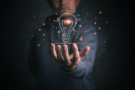 man holding icon light bulb,idea concept,,Presenting new ideas.の写真素材