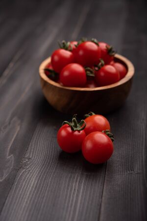 Red, ripe tomatoes on a dark background. Harvesting tomatoes.の写真素材