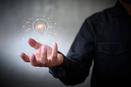 man holding icon light bulb,idea concept,,Presenting new ideas.の写真素材