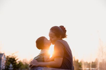 Mother and child are kissing in the park at sunset.Happy family.の写真素材