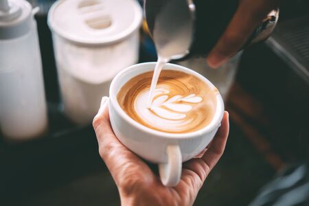 Barista made coffee latte in a coffee shop.の写真素材