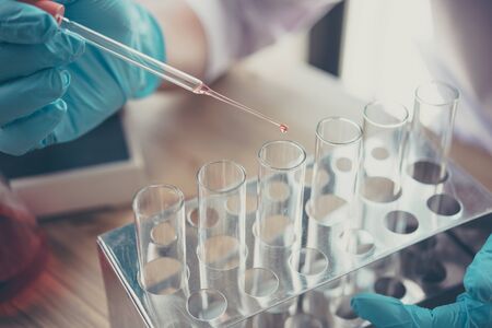 Scientists are dripping liquid into the test tube.Research in lab Concepts.の写真素材
