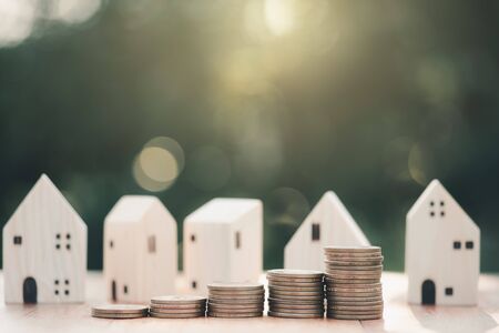 House model and stacking 1 US dollar coin.Business finance and Home loan concept.の写真素材