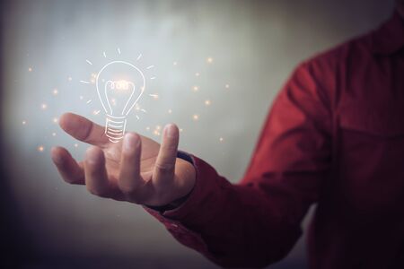 man holding icon light bulb,idea concept,,Presenting new ideas.の写真素材