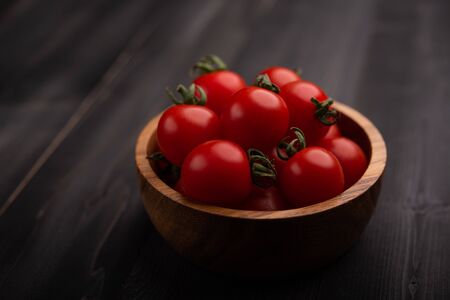 Red, ripe tomatoes on a dark background. Harvesting tomatoes.の写真素材