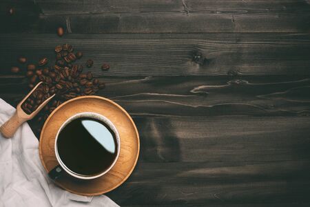 Coffee cup and beans on old wood table. Top view with copyspace for your textの写真素材