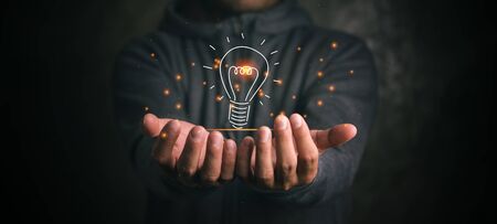 man holding icon light bulb,idea concept,,Presenting new ideas.の写真素材