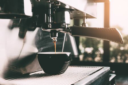 Espresso machine making coffee with cup in coffee shop.の写真素材