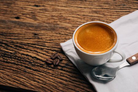 Coffee cup and beans on old wood table. espressoの写真素材