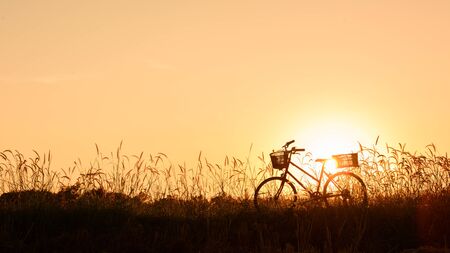 beautiful landscape image with Silhouette vintage Bicycle at sunset.classic bicycle, for greeting Cards ,post cardの写真素材