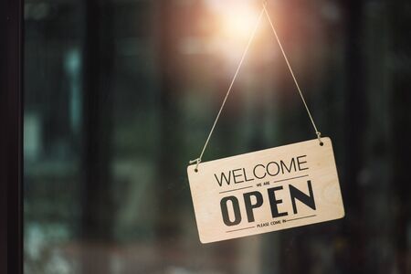"Open" on cafe or restaurant hang on door at entrance.の写真素材