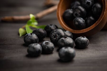 Blueberry on dark wooden table. Blueberries in wooden bowl, Blue berry detailの写真素材