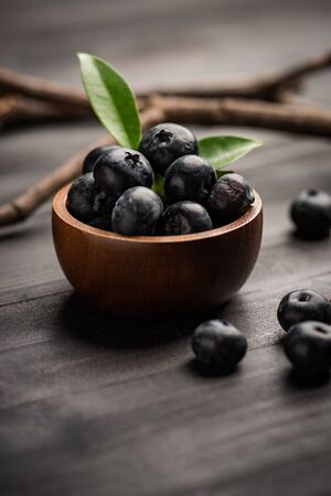 Blueberry on dark wooden table. Blueberries in wooden bowl, Blue berry detailの写真素材