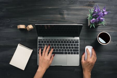 Woman working in home office hand on keyboard top view.の写真素材