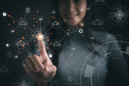 Big data analytics and business intelligence concept with chart and graph icons on a digital screen interface and a businesswoman in backgroundの写真素材