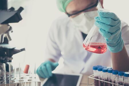 Laboratory glassware containing chemical liquid, science research background., scientist with equipment and science experimentsの写真素材