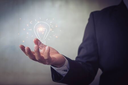 businessman holding icon light bulb,idea concept,,Presenting new ideas.の写真素材