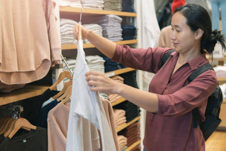 Beautiful asian girl Shopping for clothing happily.beautiful thai girlの写真素材