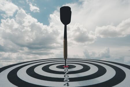 Bullseye is a target of business. Dart is an opportunity and Dartboard is the target and goal. So both of that represent a challenge in business marketing as concept.の写真素材