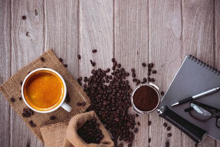 coffee espresso with coffee beans notebook,glasses,pen with copy spaceの写真素材