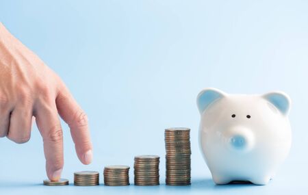Money coin stack growing graph with blue pastel background,Business Finance and Save Money investment concept.の写真素材