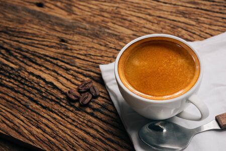 Coffee cup and beans on old wood table. espressoの写真素材