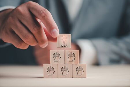 Brainstorming ideas concept.creative idea.Concept of idea and innovation. hand choose one idea of six wood block with wooden table. Business conceptの写真素材