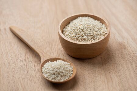 close up of white sesame seed on wooden spoon in kitchen.の写真素材