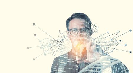 double exposure of businessman holding light bulb. idea concept with innovation and inspiration Creativity and innovative are keys to success.Concept of new idea and innovation with light bulbs.の写真素材
