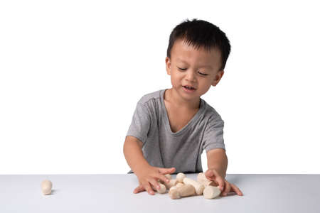 asian cute boy playing Wooden toys And he is having fun.He is 2.6 years old.Thai boy.の写真素材