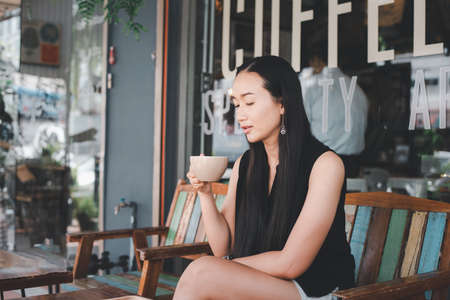 beautiful woman drinking coffee at the coffee shop.の写真素材
