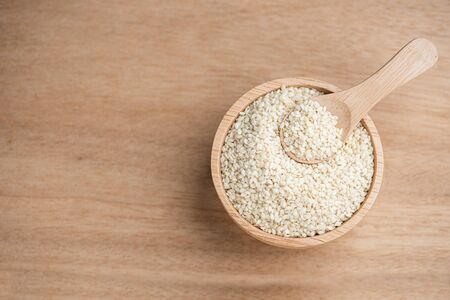 close up of white sesame seed on wooden bowl in kitchen.の写真素材