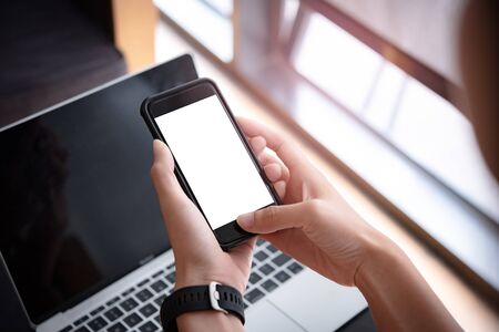 woman hand holding smartphone with blank screen for design or Advertisement.の写真素材
