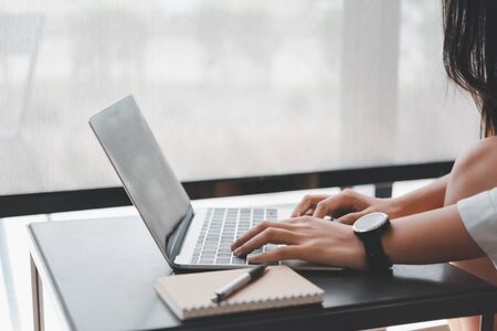 woman hand using computer laptop in coffee shop. with copy space for text or design and Advertisement.の写真素材