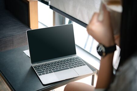 business woman working on computer with empty blank screen in the coffee shop, Concept freedom of work.の写真素材