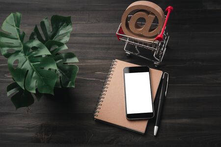 Creative workspace modern dark office desk with blank smartphone and pen on notebook,mockup topview