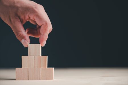 hand stack woods block step on table. business development concept.copy space.の写真素材