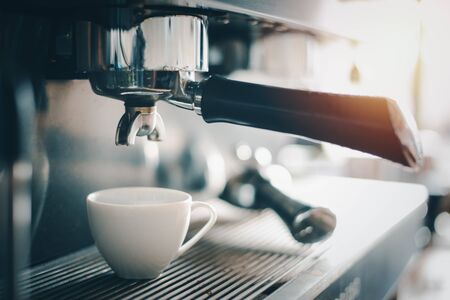 A cup of coffee is on the espresso machine,Coffee maker.の写真素材