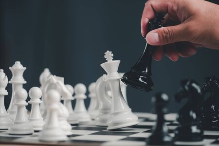hand of Businessman play with chess game. concept of business strategy and tactic.strategy, management or leadership conceptの写真素材