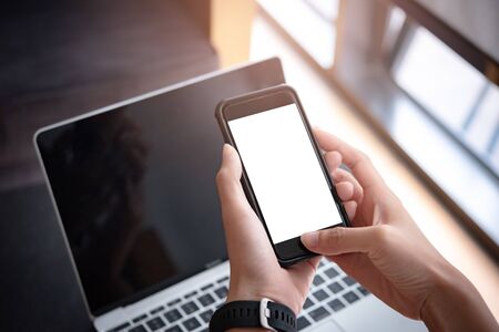 woman hand holding smartphone with blank screen for design or Advertisement.の写真素材