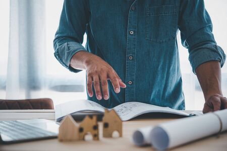 Engineers or architects is watching on model building and blueprint in working site.Construction and structure concept.の写真素材