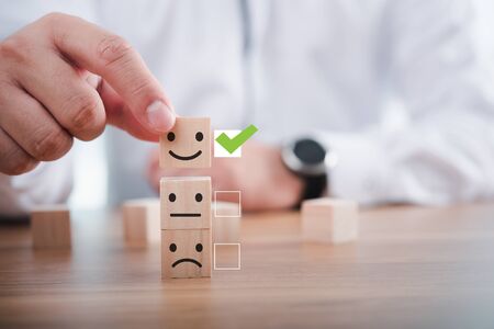 Businessman giving rating with happy icon, Customer satisfaction survey conceptの写真素材
