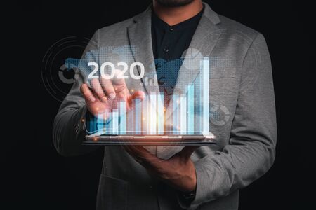 2020 New year planning business and financial concept. Businessman touching virtual screen on growth...