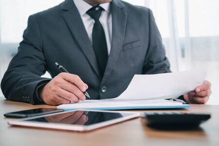 businessman or accountant professional manager working with finance document. Accountant signing finance report. Analysis working budget accounting startup economy man conceptの写真素材