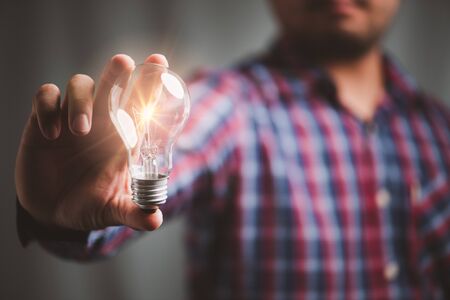 man holding light bulbs, ideas of new ideas with innovative technology and creativity.の写真素材