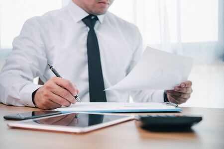 businessman or accountant professional manager working with finance document. Accountant signing finance report. Analysis working budget accounting startup economy man conceptの写真素材